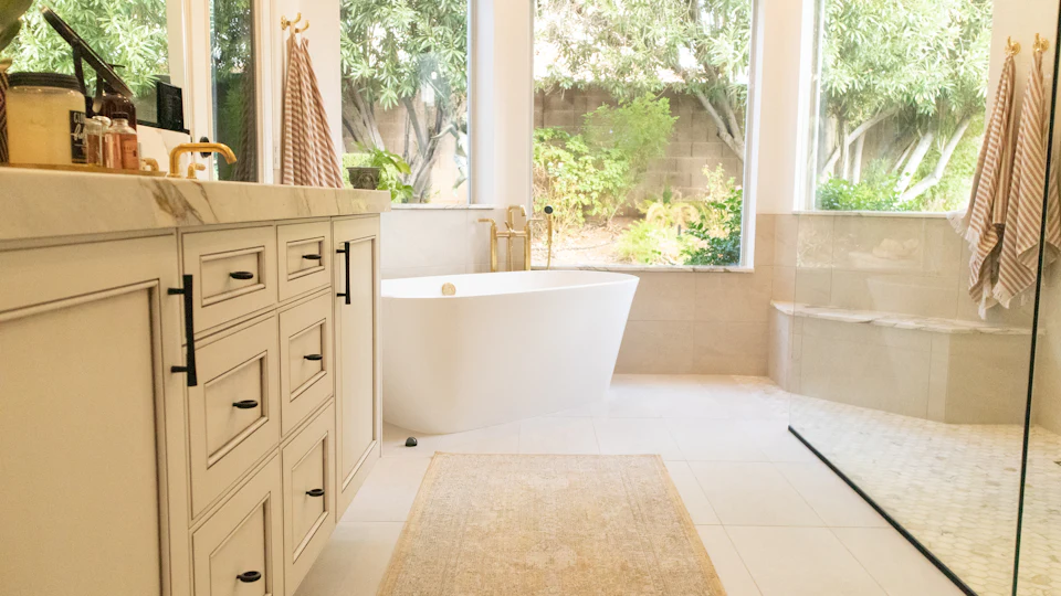Spa-like bath with a freestanding tub and garden windows