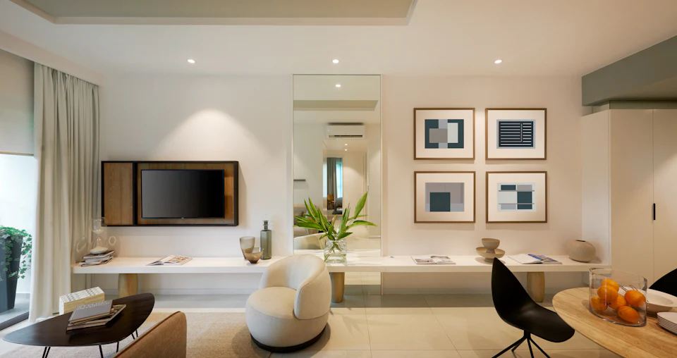 Modern condominium living area with warm lighting, framed art and a sculptural chair