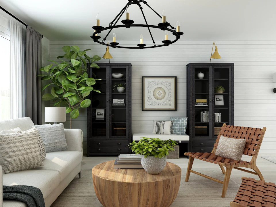 Farmhouse living room with shiplap walls, iron chandelier and black display cabinets