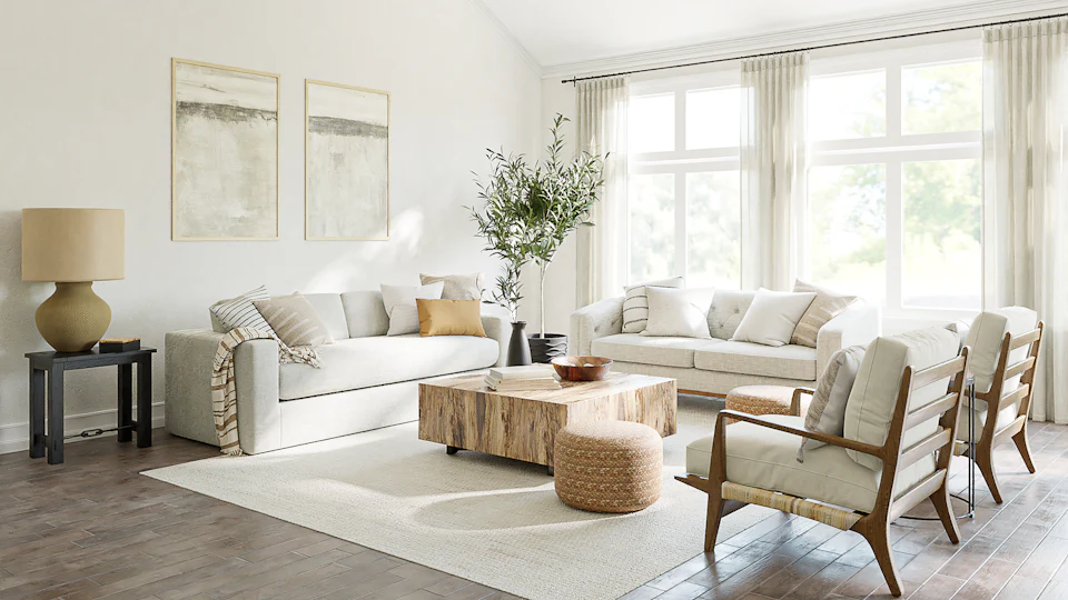 Light-filled living room staged with a white sofa, wood coffee table and woven accents